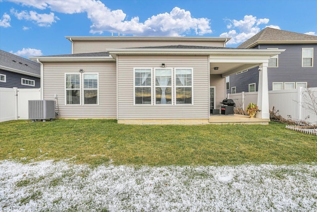 back of property featuring a lawn, a patio area, and central air condition unit