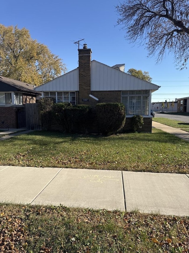 view of property exterior with a lawn