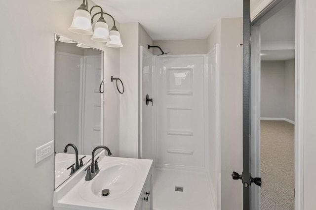 bathroom with vanity, a notable chandelier, and walk in shower