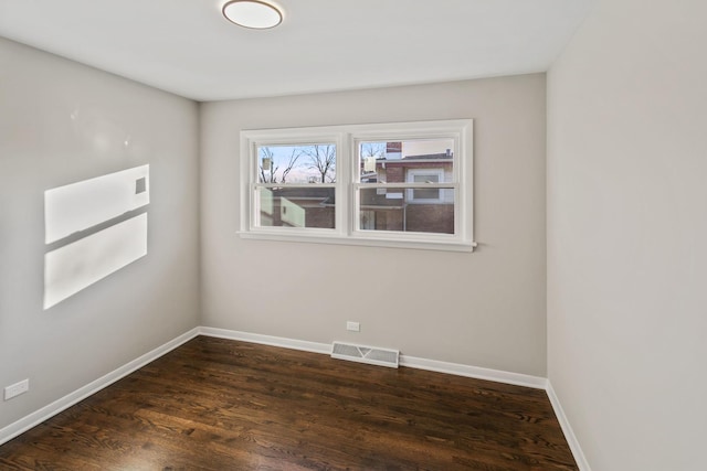 unfurnished room with dark hardwood / wood-style flooring