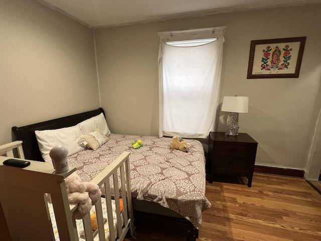 bedroom with hardwood / wood-style flooring