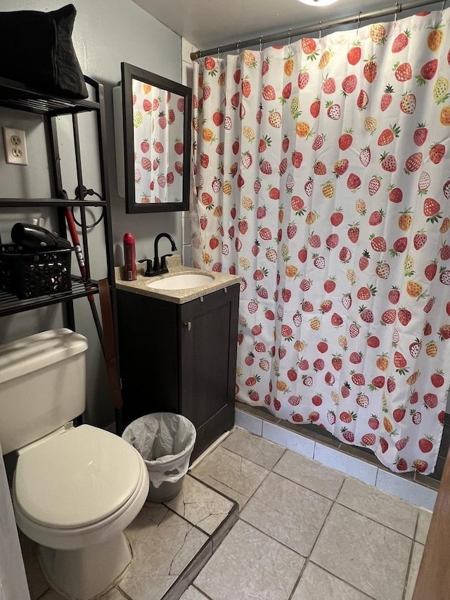 bathroom featuring tile patterned floors, vanity, toilet, and a shower with curtain