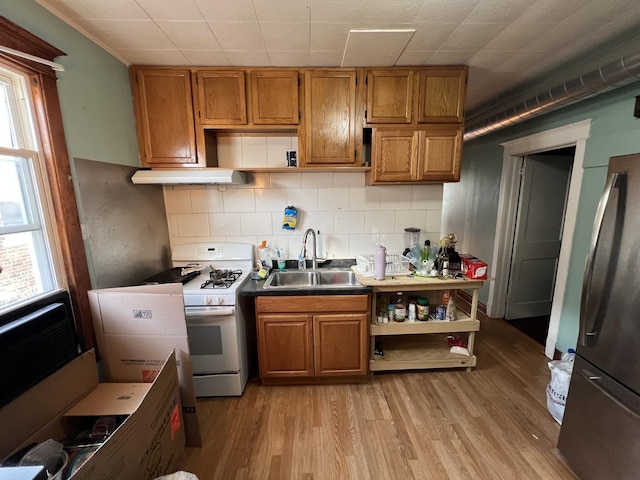 kitchen featuring stainless steel refrigerator, sink, a wealth of natural light, and gas range gas stove