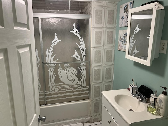 bathroom featuring vanity and combined bath / shower with glass door