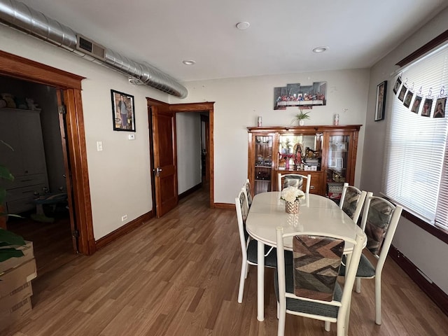 dining space featuring wood-type flooring