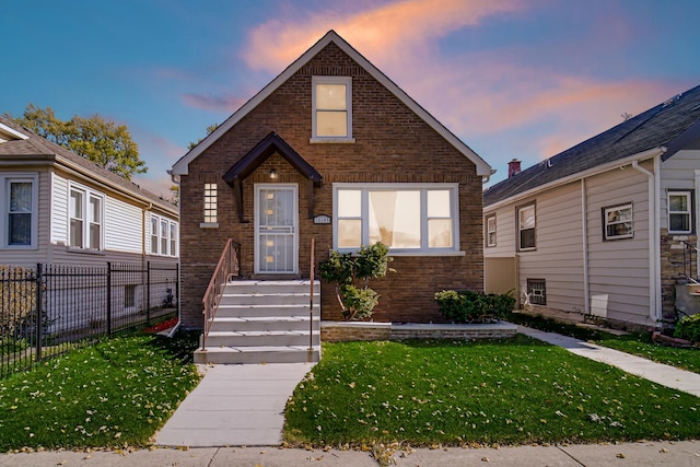 bungalow-style home featuring a lawn