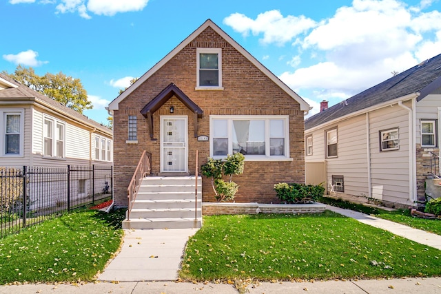 bungalow-style home with a front yard