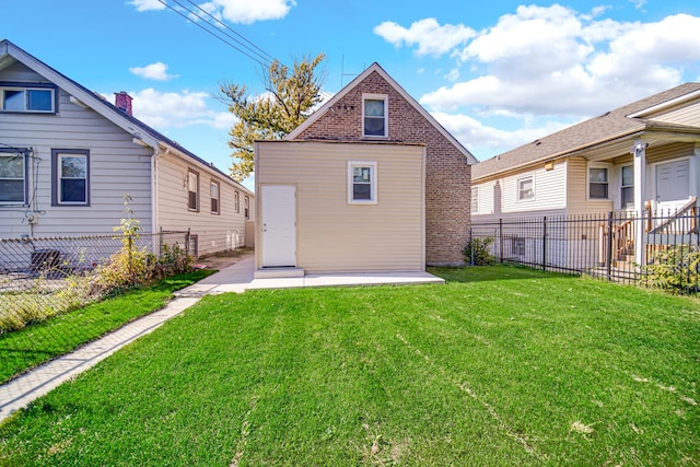 back of property with a lawn