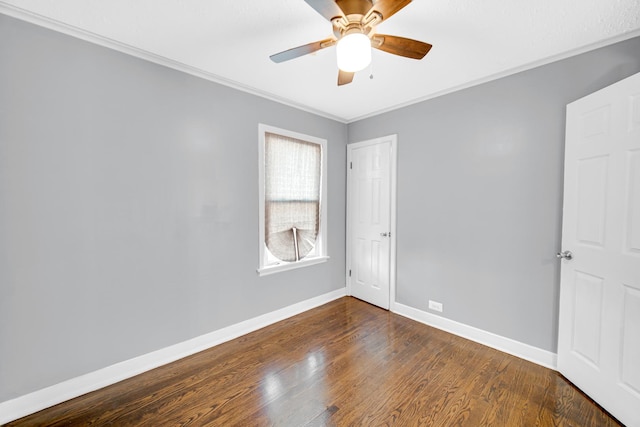 spare room featuring dark hardwood / wood-style floors, ceiling fan, and ornamental molding