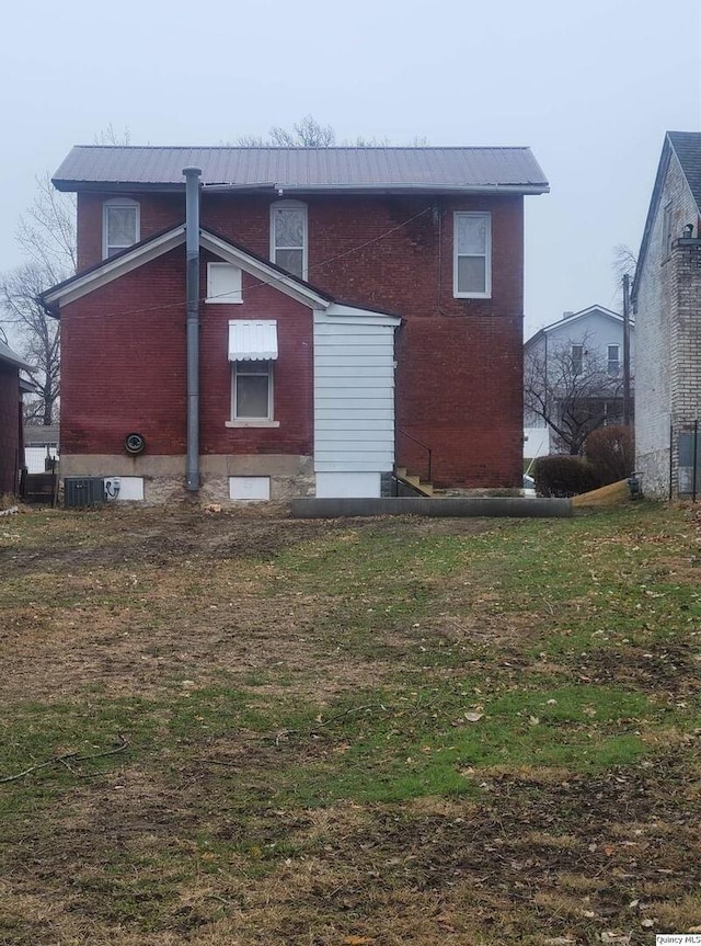 rear view of house featuring cooling unit