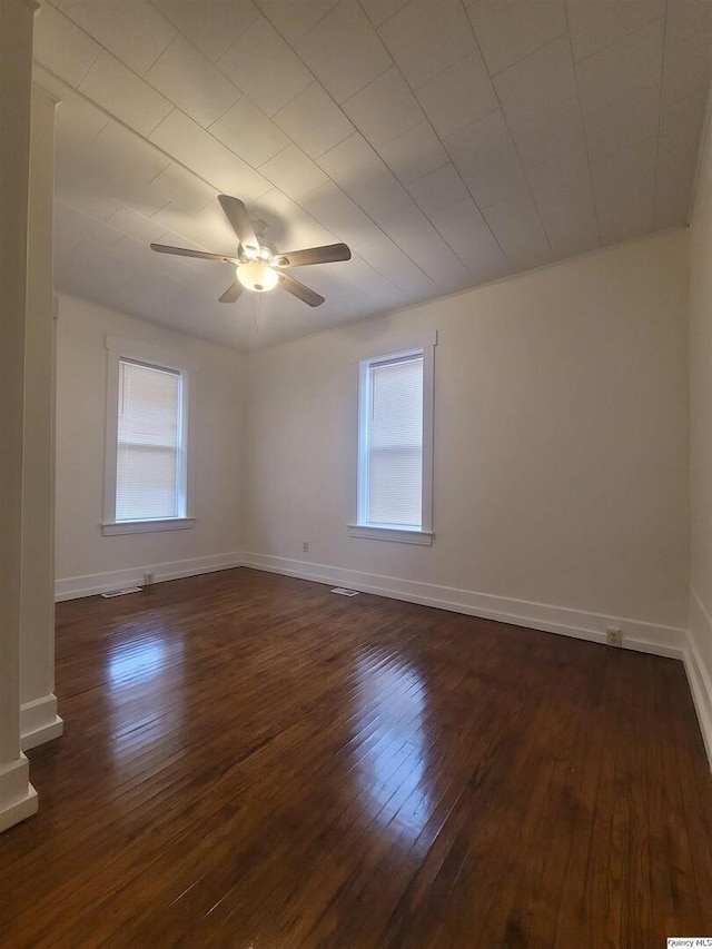 unfurnished room featuring dark hardwood / wood-style flooring, a wealth of natural light, and ceiling fan