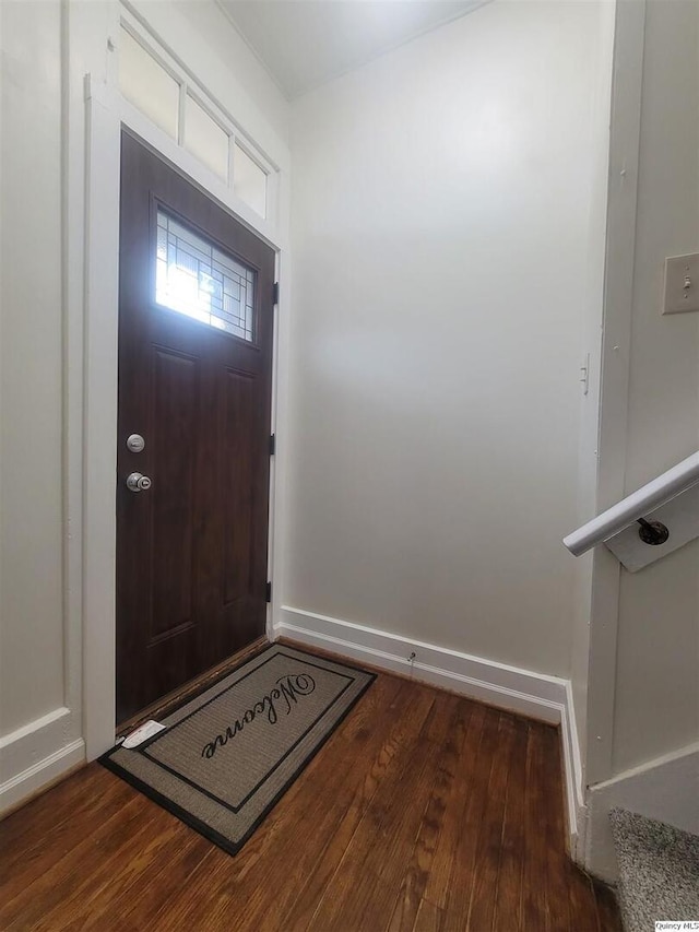 entryway with dark hardwood / wood-style flooring