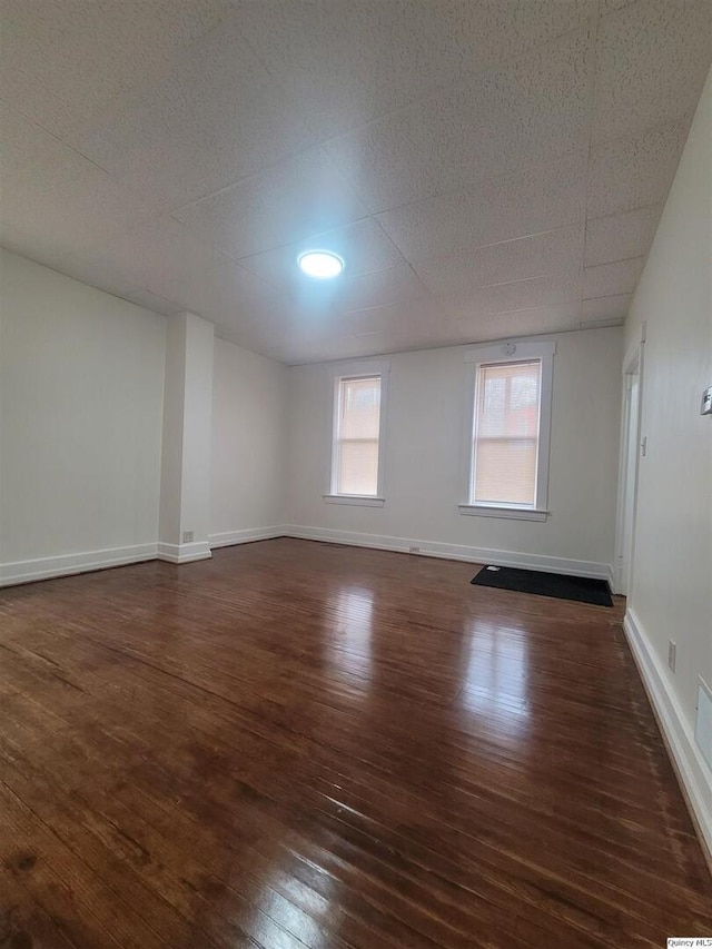 spare room with dark wood-type flooring