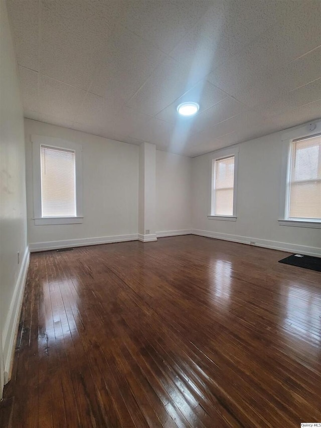 spare room with dark wood-type flooring