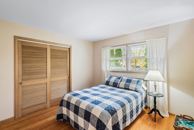 bedroom with a closet and hardwood / wood-style floors