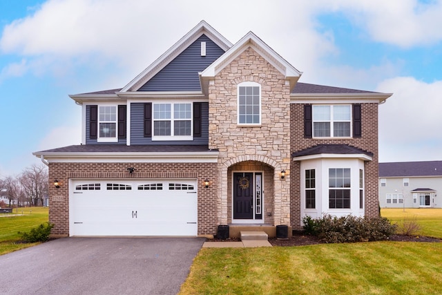 view of front of house featuring a garage and a front yard