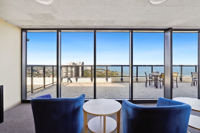 sunroom / solarium with a water view