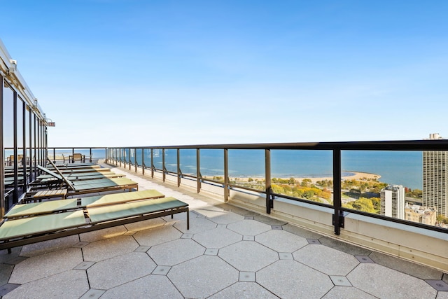 balcony with a water view and a beach view