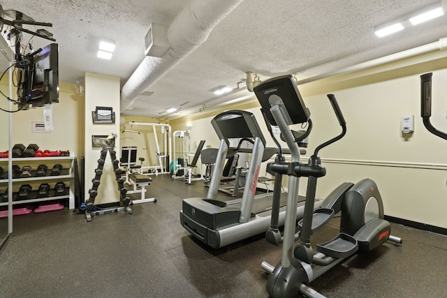 exercise room with a textured ceiling