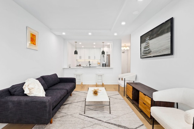 living room featuring light hardwood / wood-style flooring and sink