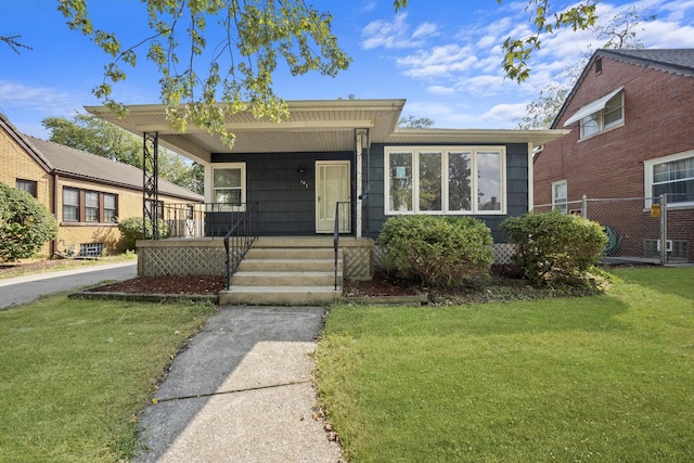 view of front of home with a front yard and covered porch