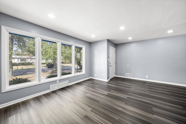 spare room with dark hardwood / wood-style flooring