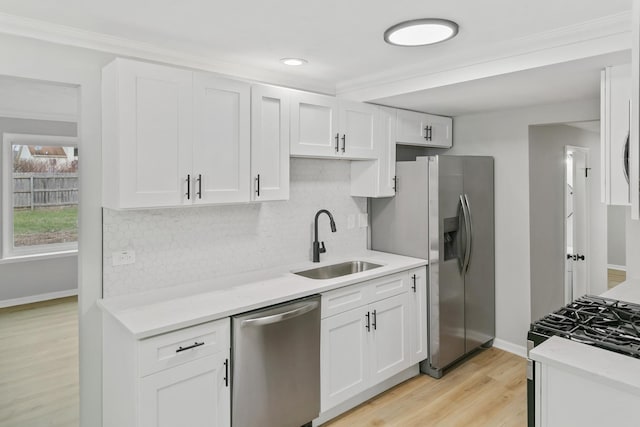 kitchen with light hardwood / wood-style flooring, stainless steel appliances, white cabinetry, and sink