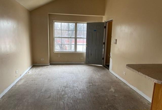 spare room with vaulted ceiling