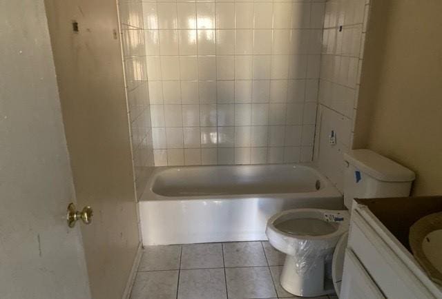 full bathroom featuring tiled shower / bath, tile patterned flooring, vanity, and toilet