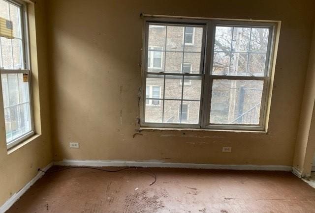 unfurnished room featuring plenty of natural light