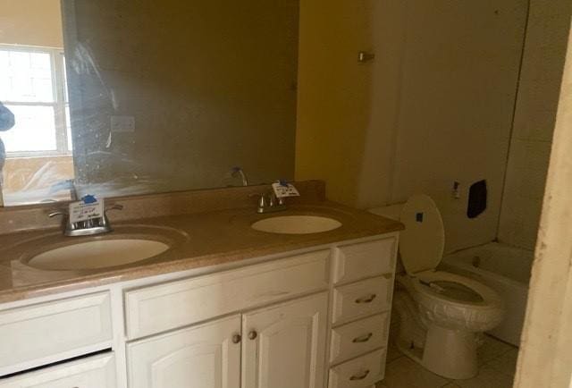 full bathroom with vanity, toilet, and bathtub / shower combination