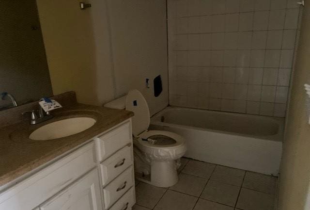 full bathroom with tile patterned floors, vanity, toilet, and tiled shower / bath combo