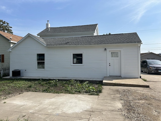 rear view of house featuring central AC unit and a patio area