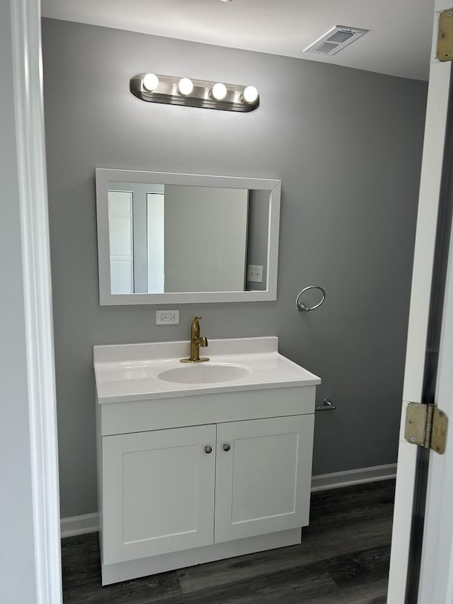 bathroom with vanity and wood-type flooring