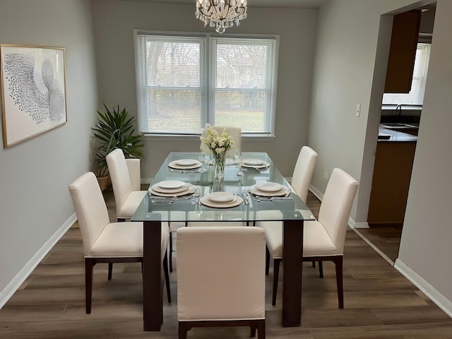 dining area with a chandelier, dark hardwood / wood-style flooring, and sink