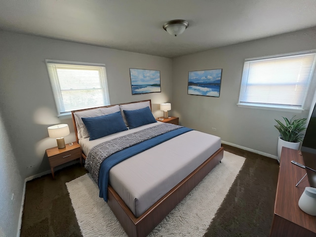 bedroom with dark colored carpet