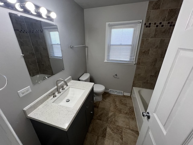 full bathroom featuring vanity, toilet, and tiled shower / bath combo