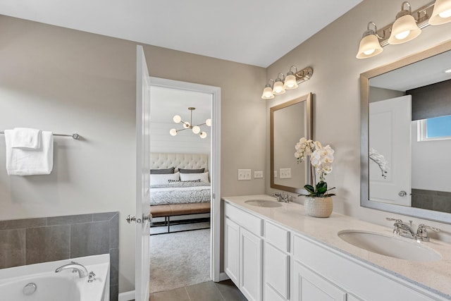 bathroom featuring tile patterned floors, vanity, and a tub