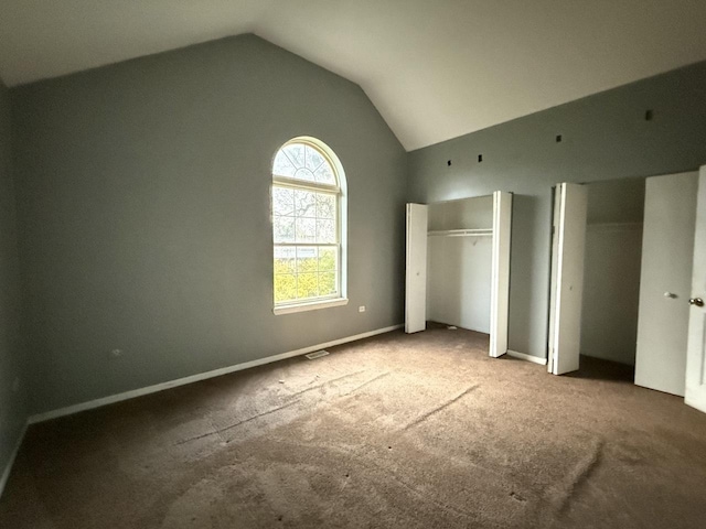 unfurnished bedroom featuring carpet floors and vaulted ceiling