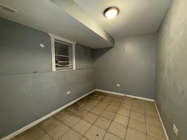 basement featuring light tile patterned floors