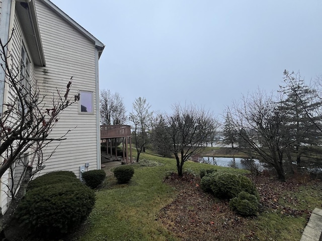 view of yard featuring a deck with water view