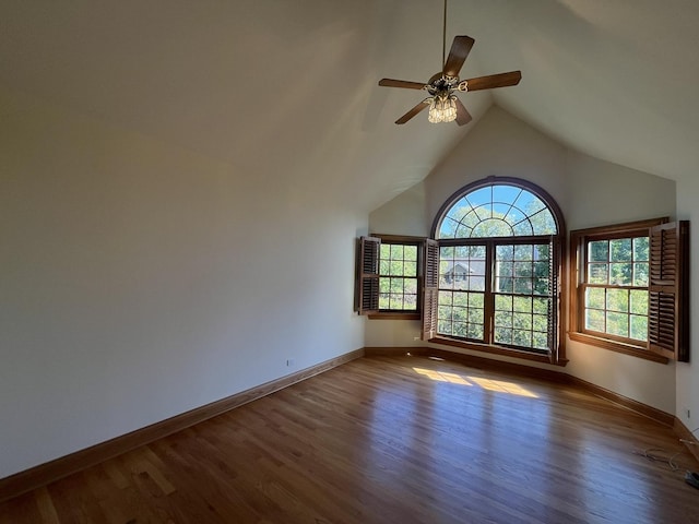 spare room featuring ceiling fan, dark wood-type flooring, and vaulted ceiling