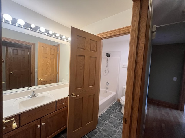 full bathroom featuring tile patterned floors, vanity, toilet, and shower / washtub combination