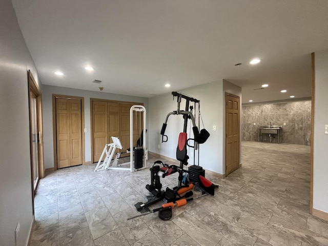 exercise room featuring tile walls