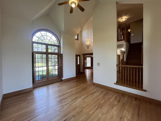 interior space with ceiling fan, light hardwood / wood-style floors, and high vaulted ceiling