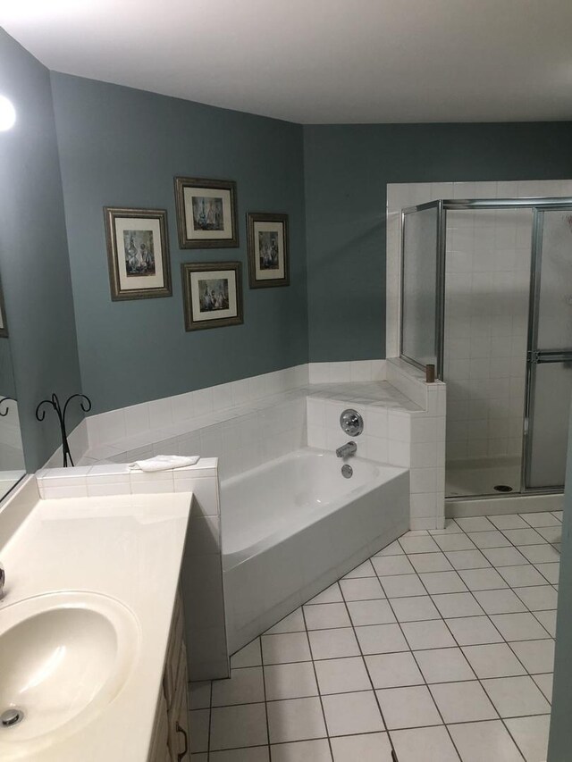 bathroom featuring tile patterned floors, plus walk in shower, and vanity