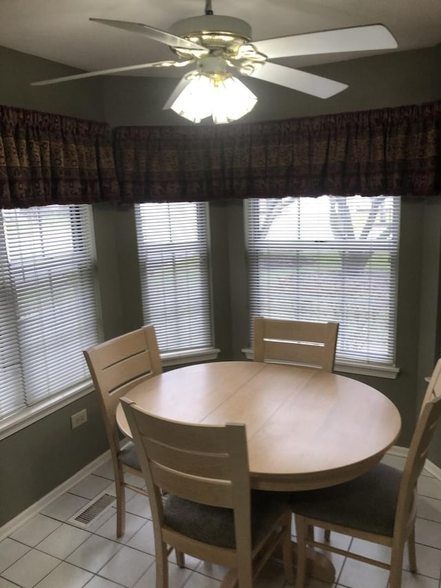 dining room with light tile patterned floors and ceiling fan