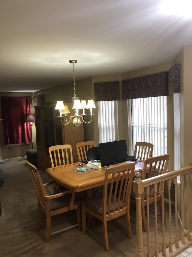 dining room with a chandelier and carpet floors