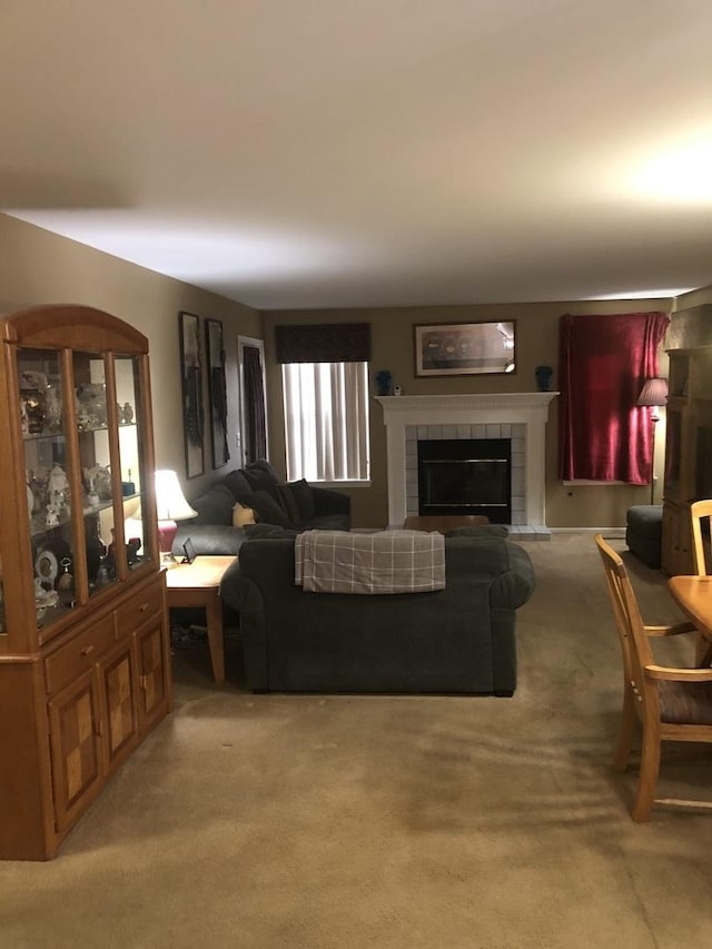 living room featuring a fireplace and light carpet