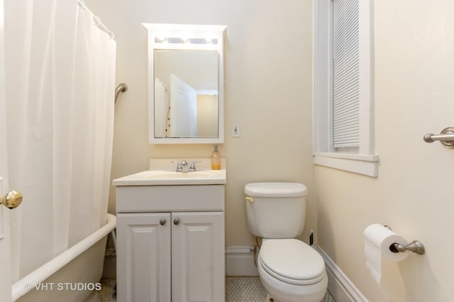 full bathroom featuring baseboards, vanity, and toilet